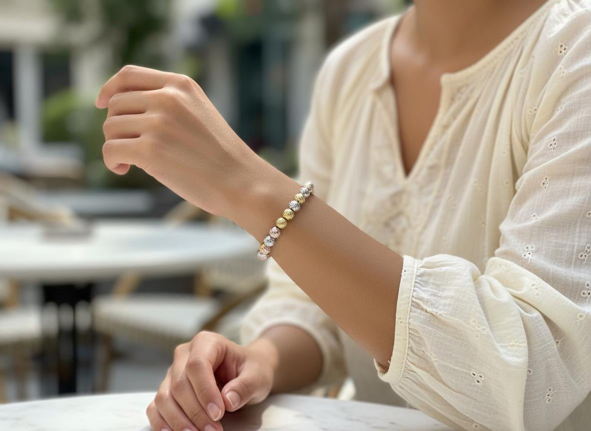 Bracciale con palline color acciaio ed oro